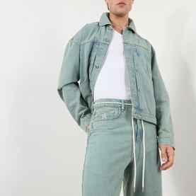 Model wearing About:Blank Jeans in murky wash, wide-leg fit with rope drawstrings, styled with matching denim jacket and white tee.