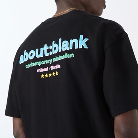 Model wearing About:Blank Box Logo T-Shirt in black, showing multicolour logo print to back, dropped shoulders and short sleeves.