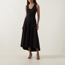 Model wearing Anne Louise Boutique black sleeveless midi dress with scoop neck, flared hi-low hem, styled with tan strappy heeled sandals.