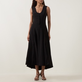 Model wearing Anne Louise Boutique black sleeveless midi dress with scoop neckline, button front, and flared skirt, styled with strappy heels
