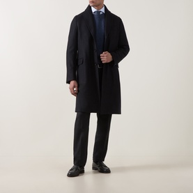 Model wearing Boglioli navy wool coat, styled with dark trousers, blue shirt and tie, and black leather shoes.