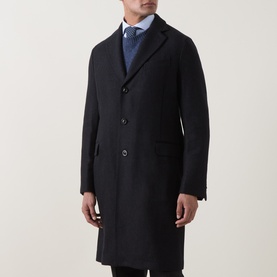 Model wearing Boglioli navy wool blend coat, styled with light blue shirt and patterned tie, single-breasted with notch lapels.