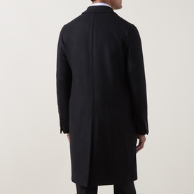 Model wearing Boglioli navy wool blend coat, rear view, showing tailored back seam and centre vent, styled with white shirt