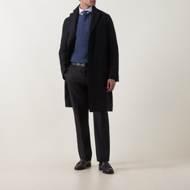 Model wearing Boglioli navy wool coat, styled with blue jumper, grey tailored trousers and black leather shoes.