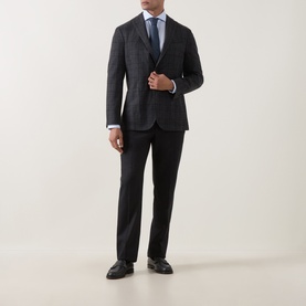 Model wearing Boglioli charcoal wool jacket with blue check, styled with white shirt, black trousers and black leather shoes.