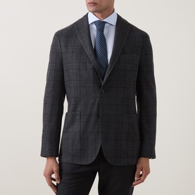 Model wearing Boglioli charcoal wool check blazer with blue shirt and navy tie, styled with dark trousers.