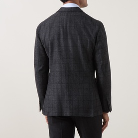 Model wearing Boglioli charcoal wool check blazer jacket, rear view, styled with dark trousers and white shirt collar visible.