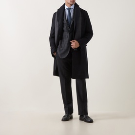 Model wearing Boglioli charcoal wool jacket styled with a dark overcoat, suit trousers, and black leather shoes.