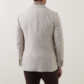 Model wearing Boglioli beige wool-blend jacket, rear view, styled with brown trousers