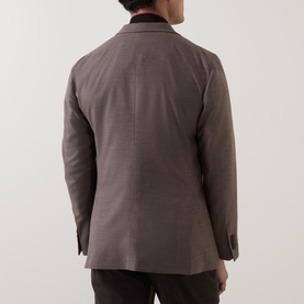 Model wearing Boglioli beige wool jacket, rear view, showing clean back seam and contrast dark velvet collar detail.