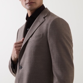 Model wearing Boglioli beige wool jacket with notch lapels and two-button front, styled with a black turtleneck