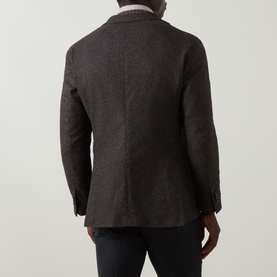 Model wearing Boglioli brown wool-blend jacket, rear view, showing single vent and two-button cuffs, styled with dark trousers