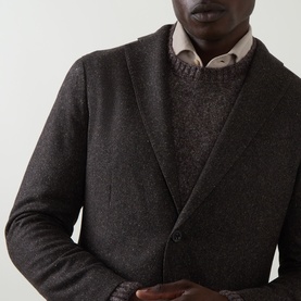 Model wearing Boglioli brown wool-blend jacket, styled with a textured knit sweater and pink shirt underneath