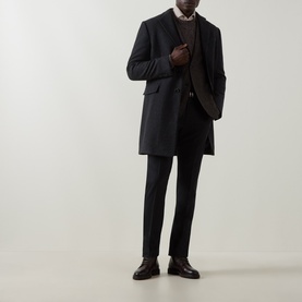Model wearing Boglioli brown wool-blend coat with dark trousers, knit layer, and black leather shoes.