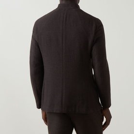 Model wearing Boglioli brown wool cashmere jacket, rear view showing back seam detail and relaxed tailored fit.