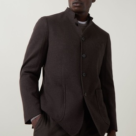 Model wearing Boglioli brown wool-cashmere jacket with mandarin collar and button front, styled with matching brown trousers.