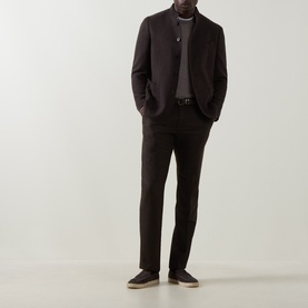 Model wearing Boglioli brown wool cashmere jacket, styled with matching dark trousers, grey top, and dark suede loafers.