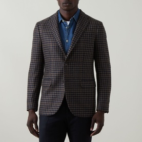 Model wearing Boglioli Houndstooth Single-Breasted Suit Jacket in navy/brown, styled with a blue denim shirt and dark trousers.