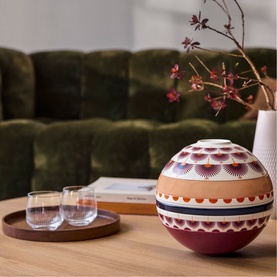 Villeroy & Boch Iconic La Boule Kyoto porcelain dinnerware set, spherical shape with multicoloured geometric patterns, styled on a wooden table.