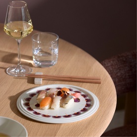 Villeroy & Boch Iconic La Boule Kyoto porcelain dinnerware set, styled with sushi on a decorative plate, wine glass and chopsticks on a wooden table.