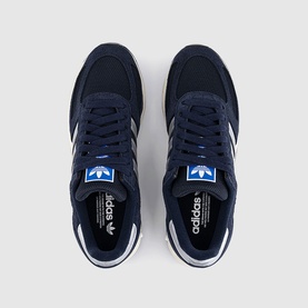 Adidas trainers in Legend Ink, navy suede and mesh upper with white stripes, blue heel tab, white rubber sole, overhead view