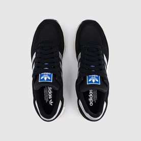 Adidas Originals black suede and mesh trainers with white three-stripe detailing, blue logo tab, and white rubber sole, overhead view