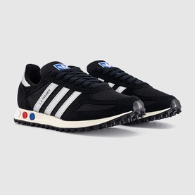 Adidas LA Trainer trainers in black with white stripes, mesh upper, red and blue heel dots, and black rubber sole