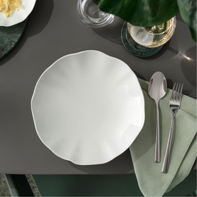 Villeroy & Boch Pura Bowl in white bone porcelain, scalloped edge design, styled on grey table with cutlery and green napkin