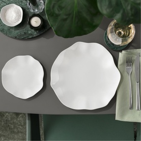 Villeroy & Boch Pura Bread Plate in white bone porcelain with scalloped edge, styled on grey table with matching dinner plate and greenery