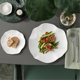 Villeroy & Boch Pura Bread Plate in white bone porcelain, styled on a table alongside a dinner plate with a salad and a wine glass