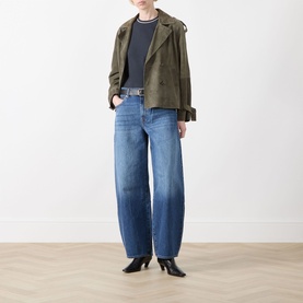 Model wearing Seven Jeans Skyfrost wide-leg jeans, styled with a cropped khaki jacket, navy top and black heeled ankle boots.