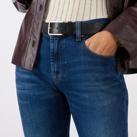Black leather belt with silver-tone rectangular buckle, shown worn through belt loops of blue denim jeans