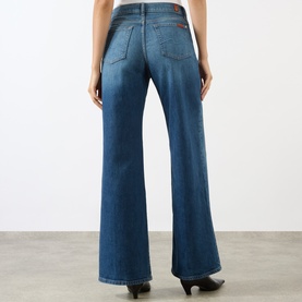Model wearing Seven Jeans Lotta Wide-Leg Jeans in Blue Core, mid-wash denim, wide-leg silhouette, five-pocket styling, tobacco stitching, rear view