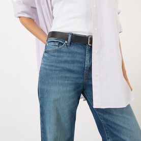 Model wearing Seven Jeans Lotta Wide-Leg Jeans in Blue Core mid wash with a black belt and white striped shirt.