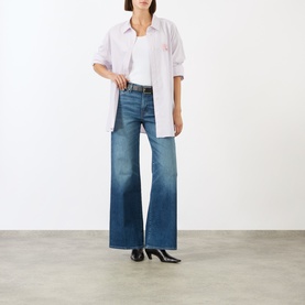 Model wearing Seven Jeans Lotta Wide-Leg Jeans in Blue Core mid wash with wide leg, styled with a white shirt and black heels.