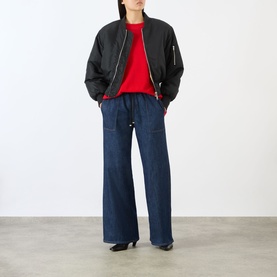Model wearing Seven Jeans Wide Leg jeans in Halona dark indigo, with black bomber jacket and red top, kitten heel shoes.