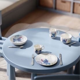 Villeroy & Boch Disney Stitch Children's 4-Piece Cutlery Set in metallic stainless steel, styled on a blue children's table with Stitch-themed