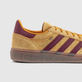 Adidas Handball Spezial trainer in yellow suede with burgundy stripes and gum sole, close-up side detail view