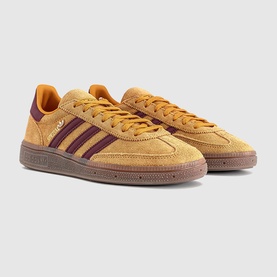 Adidas trainers in preloved yellow with burgundy suede three-stripe detail, tan rubber cupsole, flat laces, low-top silhouette