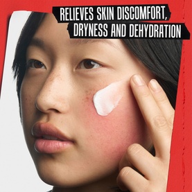 Model applying white cream to cheek, with text overlay: Relieves skin discomfort, dryness and dehydration