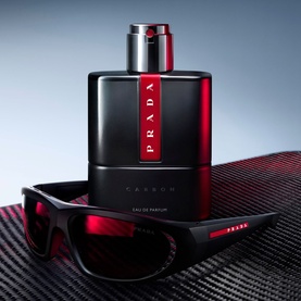 Prada Beauty Luna Rossa Carbon Eau de Parfum 50ml, black and red bottle with silver cap, styled with matching Luna Rossa sunglasses