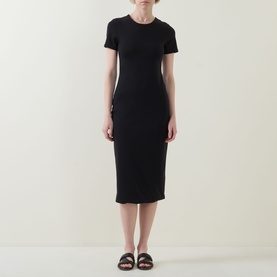 Model wearing Spanx Classic Black ribbed midi dress with short sleeves and crew neck, styled with black flat sandals