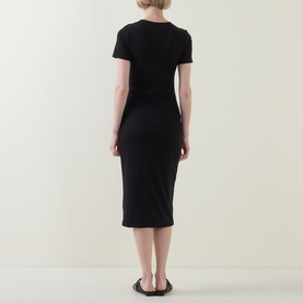 Model wearing Spanx Classic Black midi dress, short sleeves, form-fitting silhouette, shown from the back with black sandals