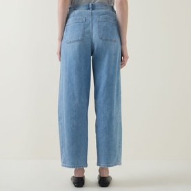 Model wearing Spanx SPANXsupersmooth&trade; Authentic 360 Lightweight Utility Barrel Leg Jeans in Seaside Blue, rear view showing patch pockets and barrel