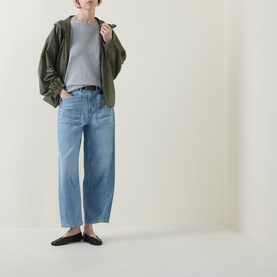 Model wearing Spanx SPANXsupersmooth&trade; Authentic 360 Lightweight Utility Barrel Leg Jeans in Seaside Blue, styled with khaki jacket and grey tee