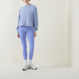 Model wearing Spanx SPANXshape&reg; BodyLine Sheerious Leggings in Hyacinth, styled with matching sweatshirt and white trainers.