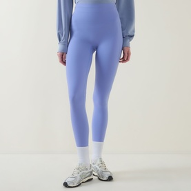 Model wearing Spanx SPANXshape&reg; BodyLine Sheerious Leggings in Hyacinth, styled with a light blue sweatshirt and white trainers.