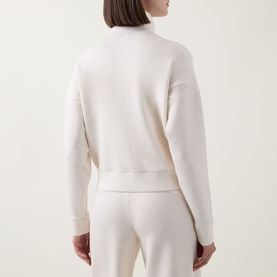 Model wearing Spanx AirEssentials&reg; Track Jacket in Oatmeal Heather, rear view, high neck, long sleeves, ribbed trims, styled with matching trousers.