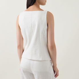 Model wearing Spanx Ivory Top, back view, sleeveless with square neckline, styled with matching ivory wide-leg trousers.