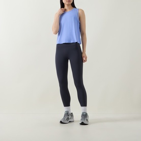 Model wearing Spanx Hyacinth active tank top, styled with dark navy leggings and grey trainers